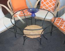 63    Wrouht iron and glass topped table with 4 wicker and iron chairs. New out door grade cushions. Suitable for conservatories     $195